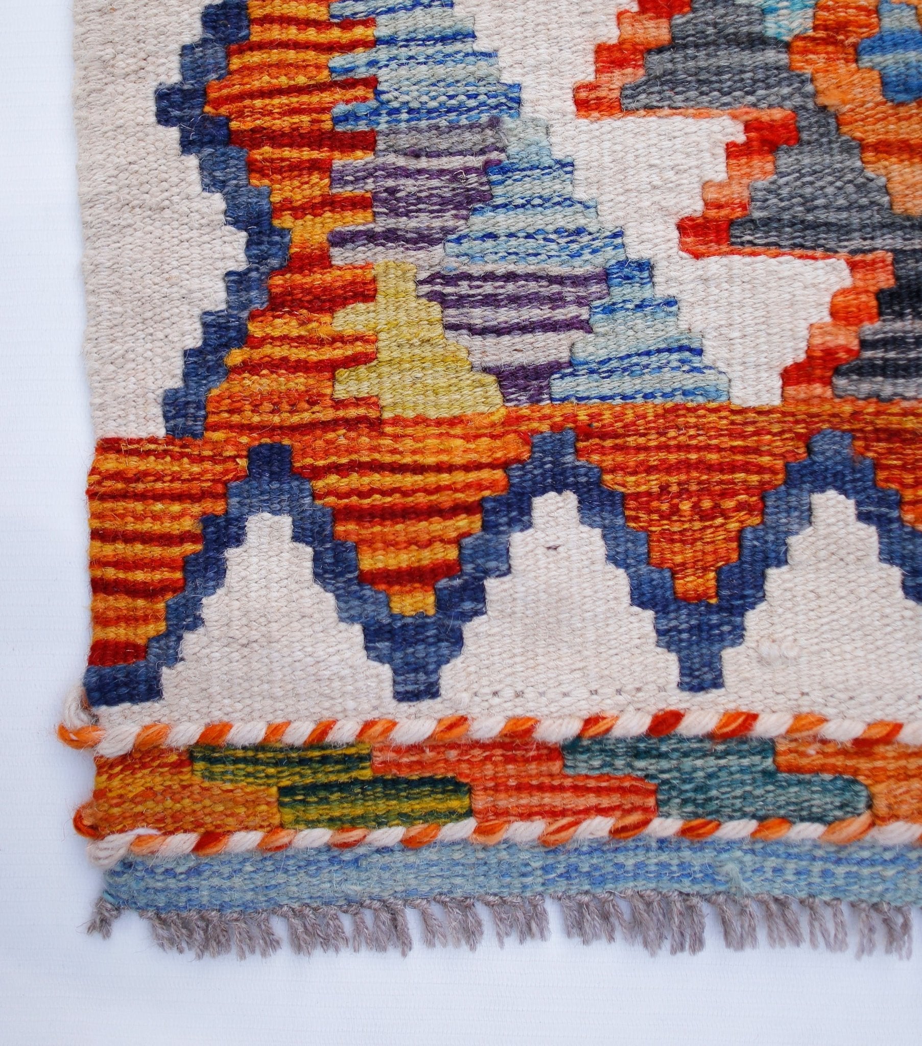 Handwoven Afghan Maimana kilim runner featuring vibrant geometric patterns in wool.