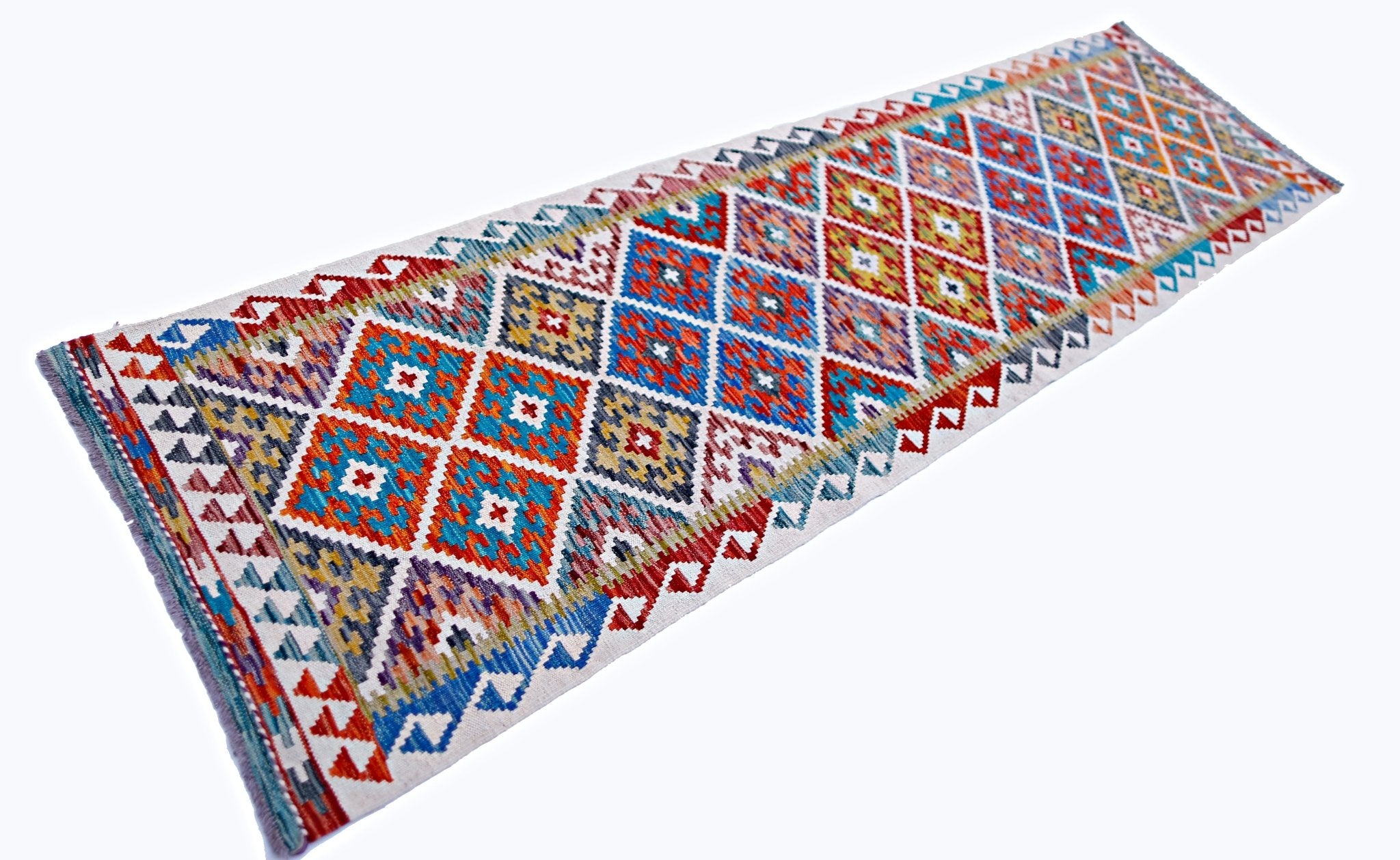 A handmade Afghan Maimana wool runner rug featuring a vibrant geometric diamond pattern.