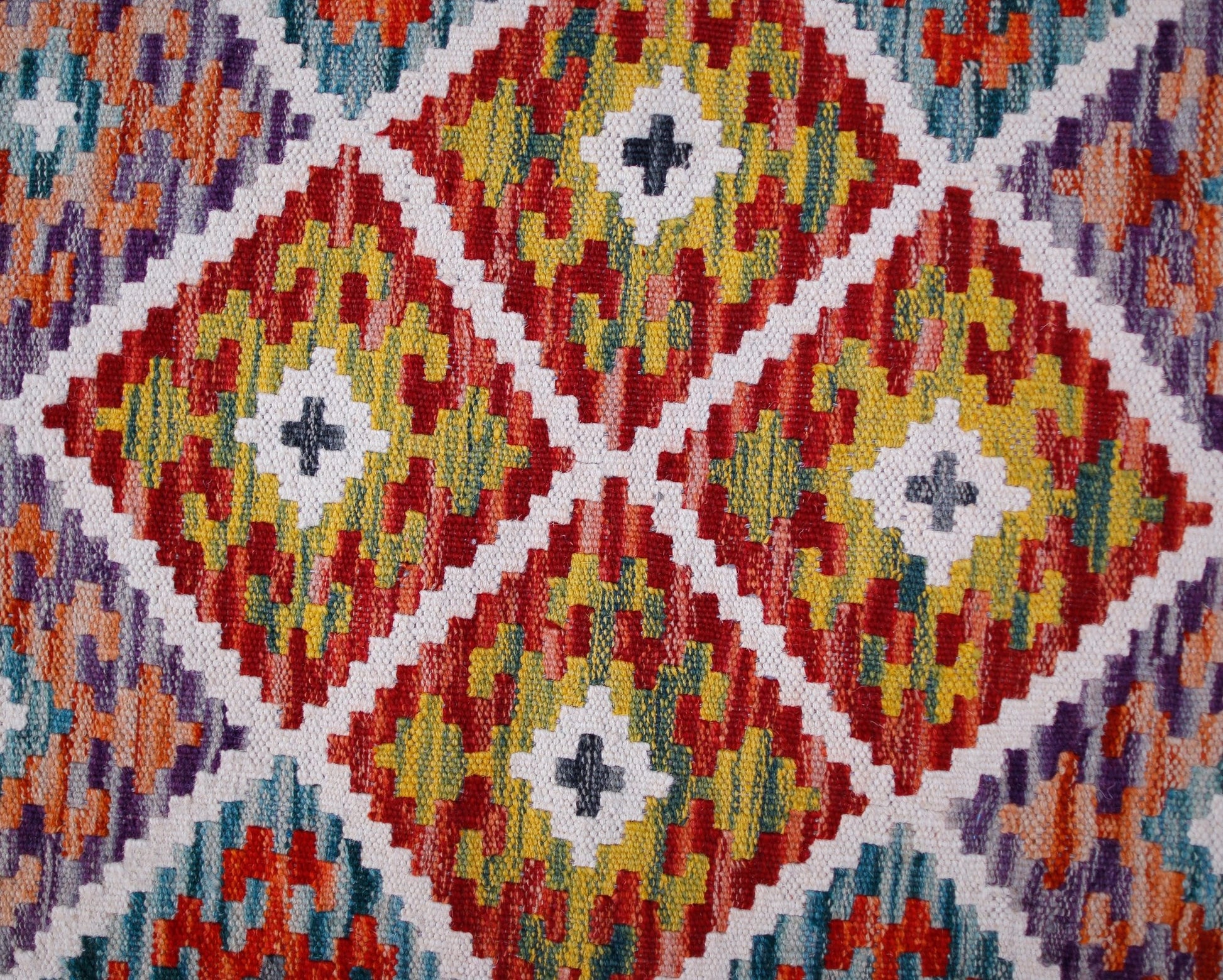 Handwoven Afghan Maimana kilim runner featuring a vibrant geometric diamond pattern in wool.