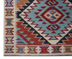 Handwoven Afghan Maimana wool runner featuring a geometric pattern in blue, red, and cream tones.