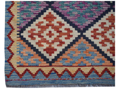 Handwoven Afghan Maimana wool runner featuring a geometric diamond pattern in vibrant colors.