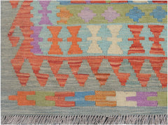 Handmade Afghan Maimana kilim runner featuring colorful geometric patterns on a grey background.