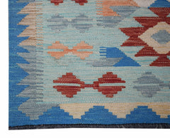 Handwoven Afghan Maimana wool runner featuring geometric patterns in blue, red, and beige.