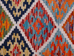 Handwoven Afghan Maimana kilim runner featuring a vibrant geometric diamond pattern in wool.