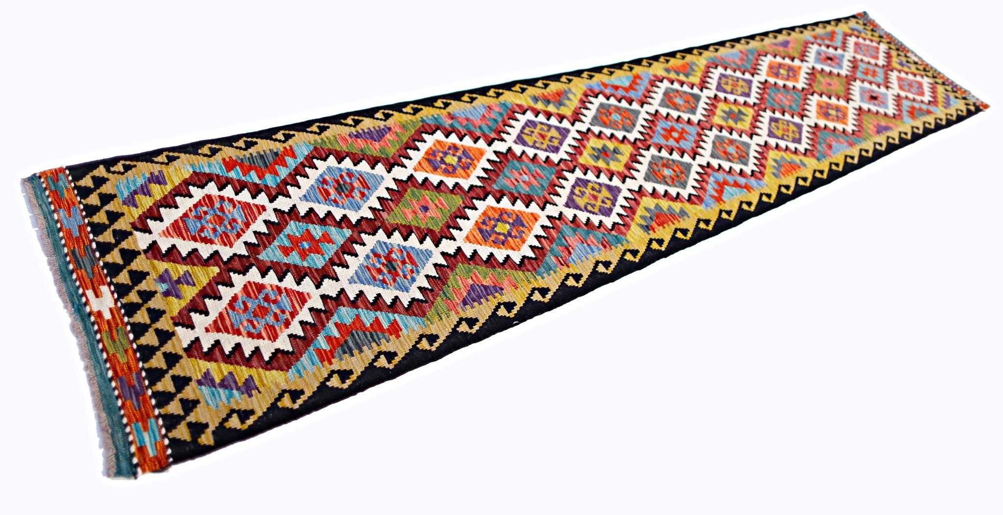 A handmade Afghan Maimana wool runner rug featuring a colorful geometric diamond pattern.