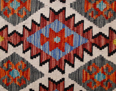 Handwoven Afghan Maimana kilim runner featuring a geometric pattern in red, blue, and grey wool.