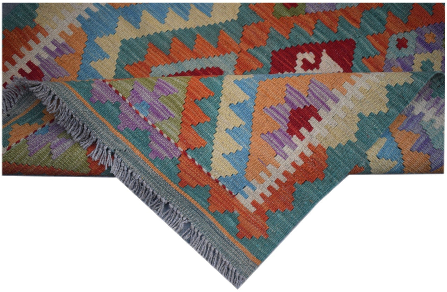 A handmade Afghan Maimana kilim runner featuring vibrant geometric patterns in wool.