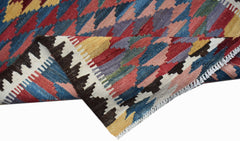 A handmade Afghan Maimana wool kilim runner featuring a colorful geometric pattern.