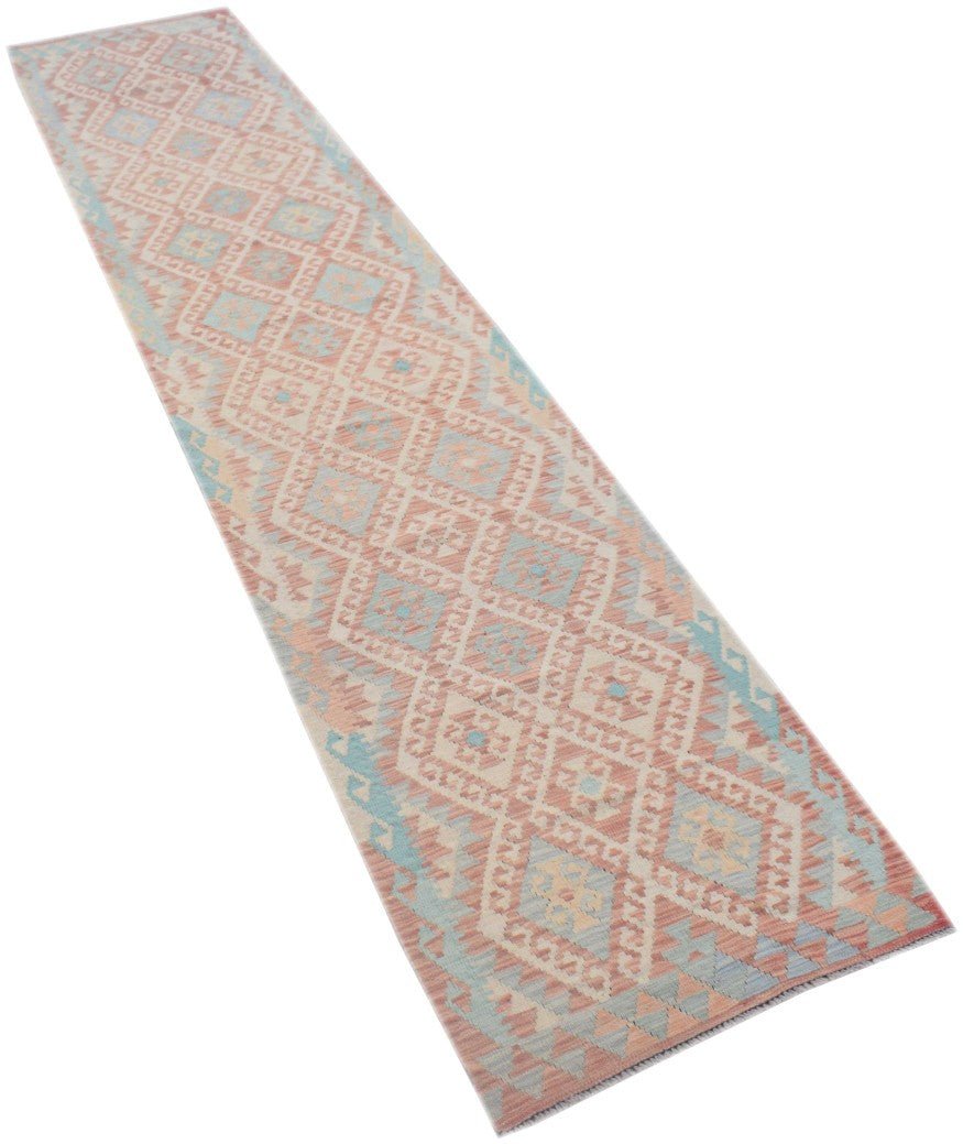 Handmade Afghan Maimana wool runner rug featuring a geometric diamond pattern in soft pastel tones.