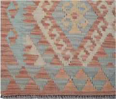 Handwoven Afghan Maimana kilim runner featuring a geometric pattern in muted red, blue, and cream.