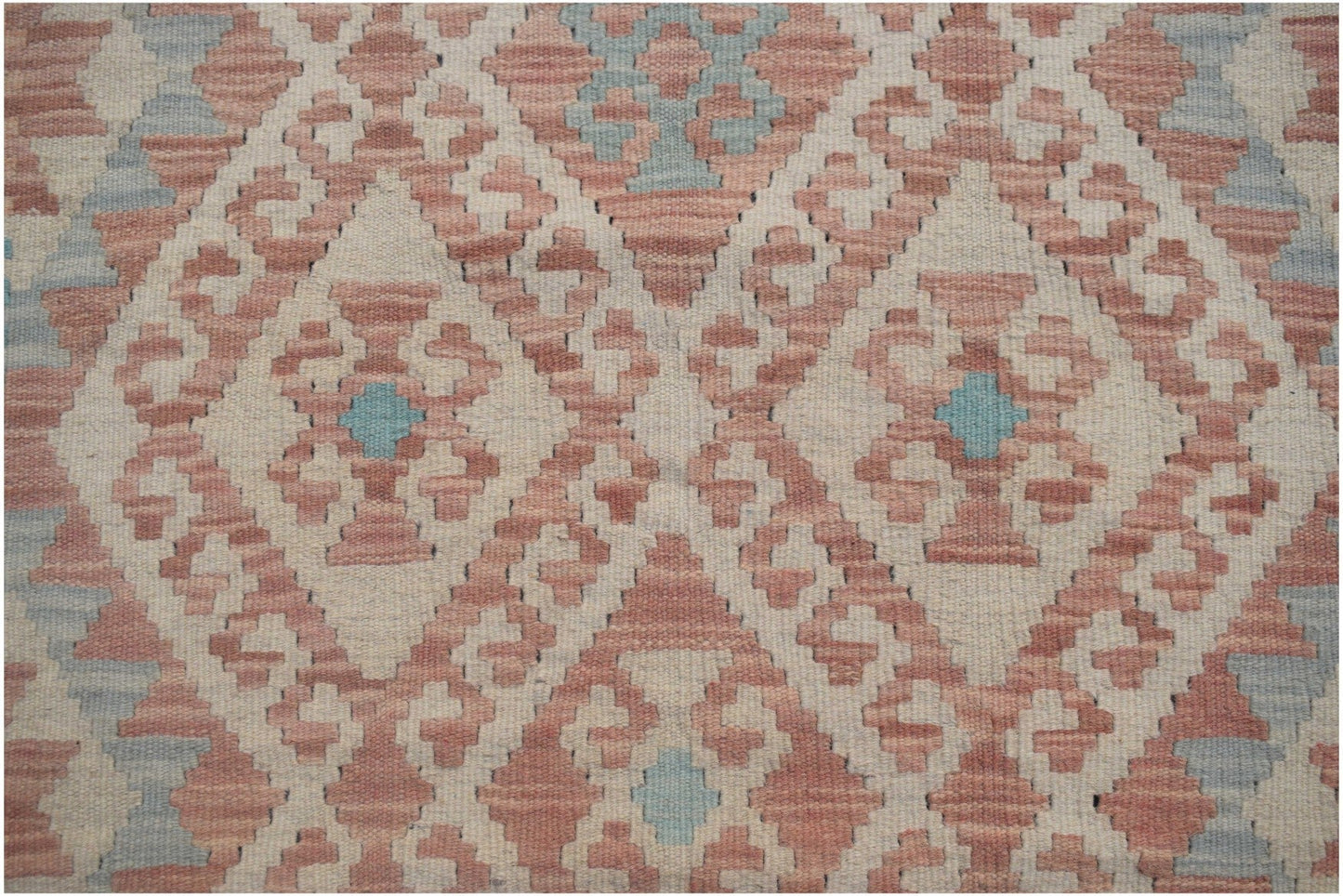 Handmade Afghan Maimana kilim runner featuring a geometric diamond pattern in pink and blue.
