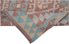 A handmade Afghan Maimana kilim runner featuring a geometric pattern in red, blue, and beige.