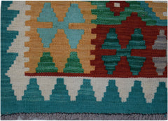 Handwoven Afghan Maimana wool runner featuring a geometric pattern in teal, red, and gold.