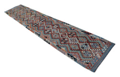 A handmade Afghan Maimana wool runner rug featuring a colorful geometric diamond pattern.