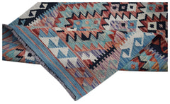 A handwoven Afghan Maimana wool runner featuring a geometric pattern in blue, red, and cream.