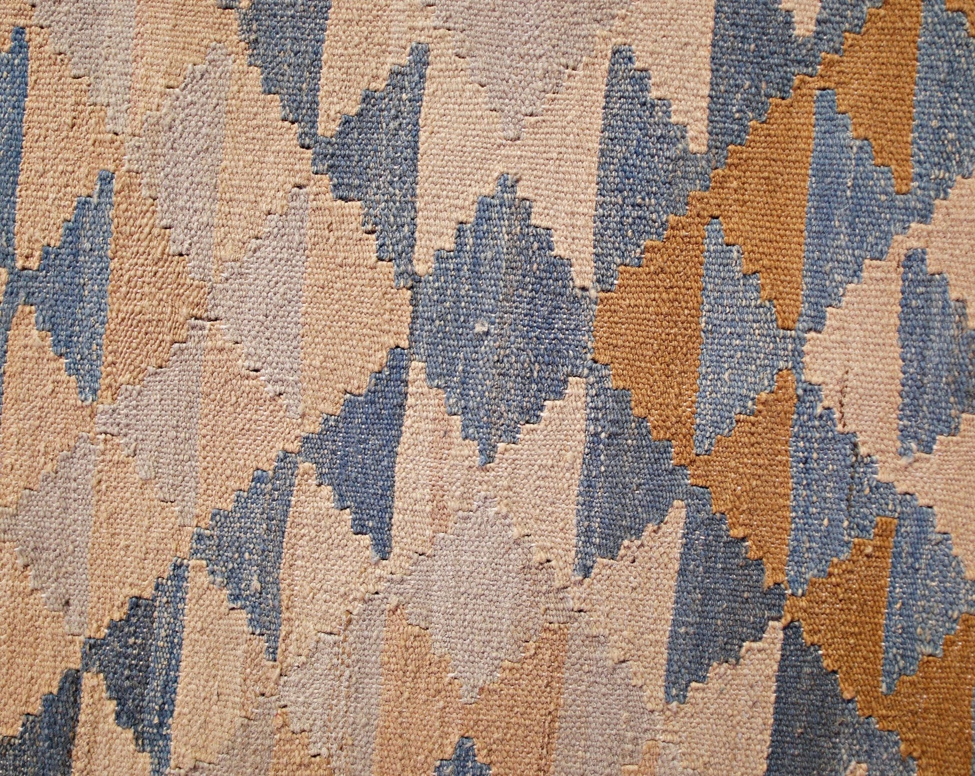 A handwoven Afghan Maimana kilim runner featuring a geometric diamond pattern in blue and tan.