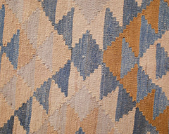 A handwoven Afghan Maimana kilim runner featuring a geometric diamond pattern in blue and tan.