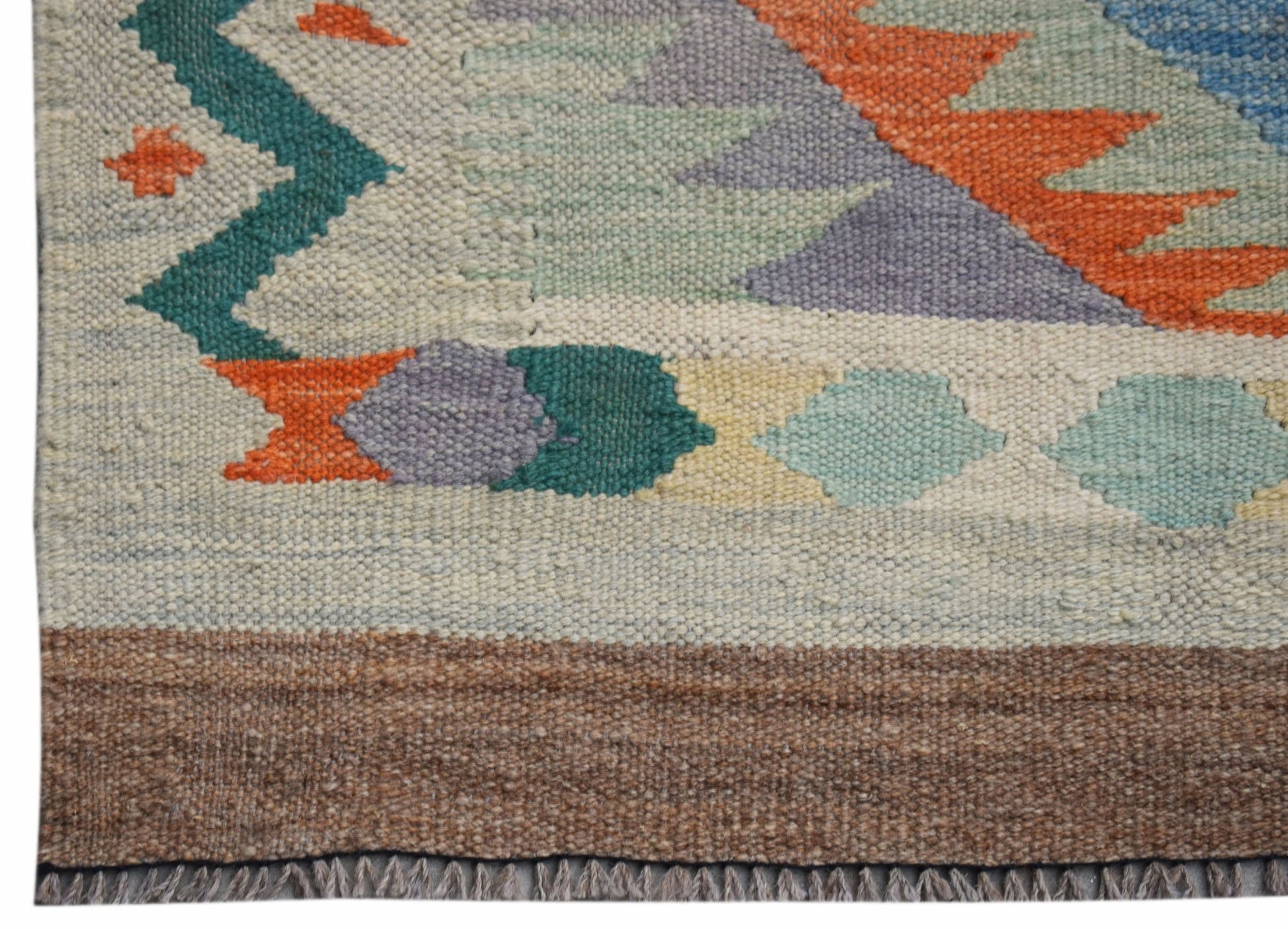 A handwoven Afghan Maimana wool kilim runner featuring geometric patterns in vibrant colors.