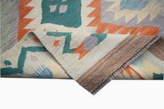 A handmade Afghan Maimana wool kilim runner featuring geometric patterns in vibrant colors.