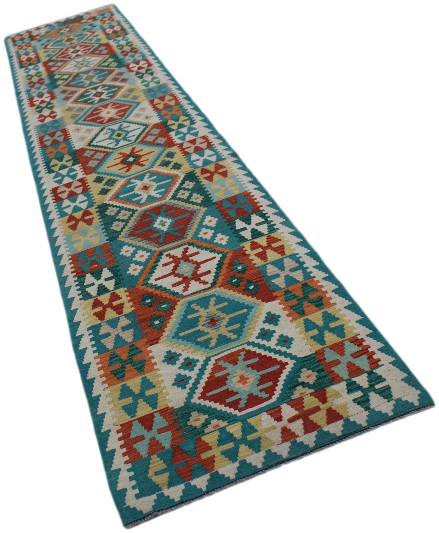 A handmade Afghan Maimana wool runner rug featuring a colorful geometric pattern on a teal border.