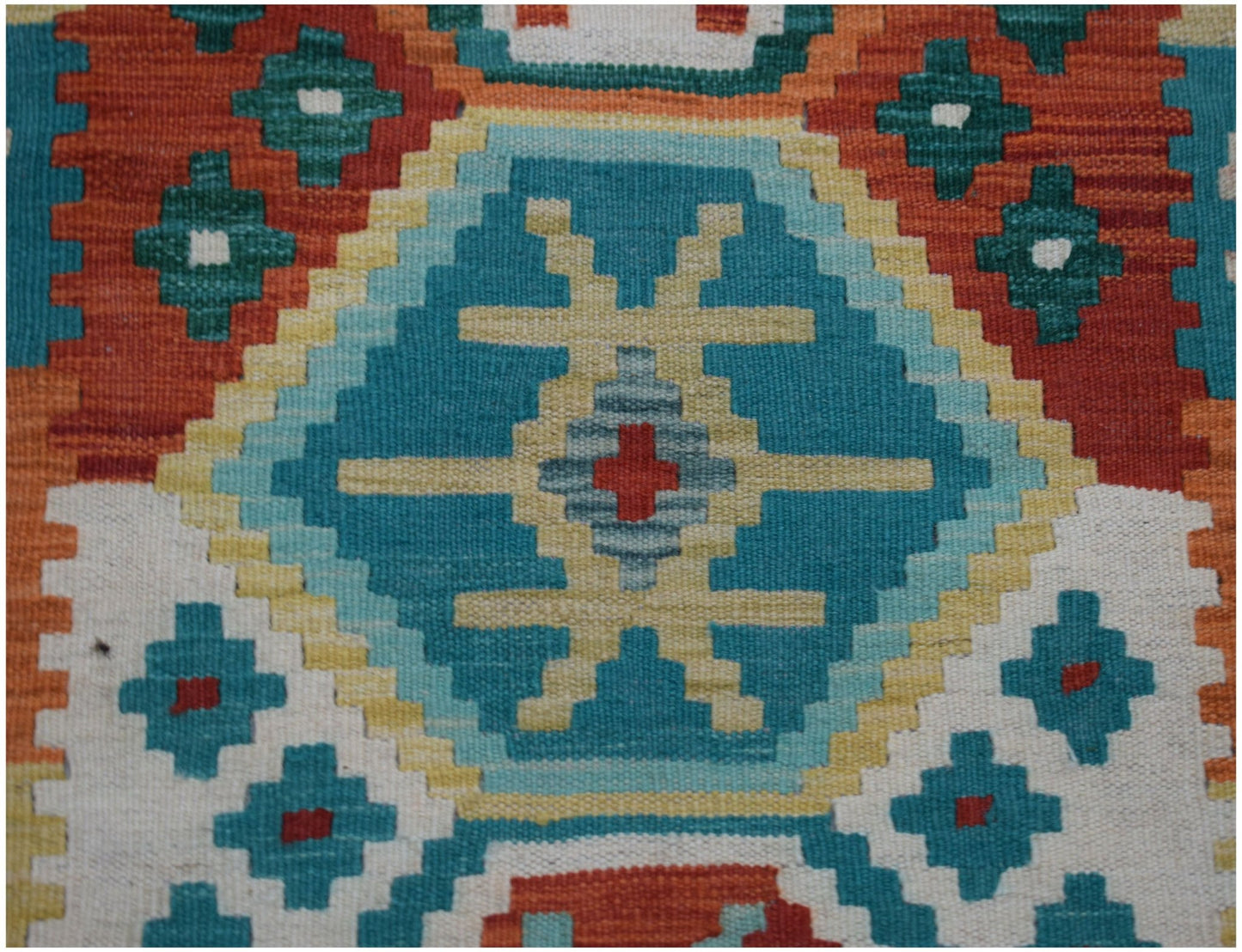Handwoven Afghan Maimana kilim runner featuring a geometric pattern in teal, orange, and cream.