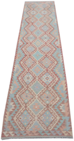 A handmade Afghan Maimana wool runner rug featuring a repeating geometric diamond pattern in soft pastel tones.