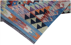 A handwoven Afghan Maimana kilim runner featuring a vibrant geometric pattern in wool.