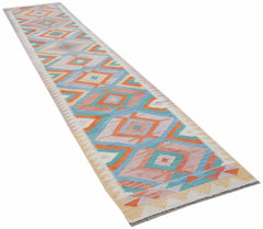 A handmade Afghan Maimana wool runner rug featuring a colorful geometric diamond pattern.