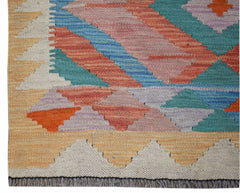 Handwoven Afghan Maimana wool runner featuring a colorful geometric pattern and fringed edges.