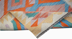 A handwoven Afghan Maimana Kilim runner featuring a colorful geometric pattern on wool.