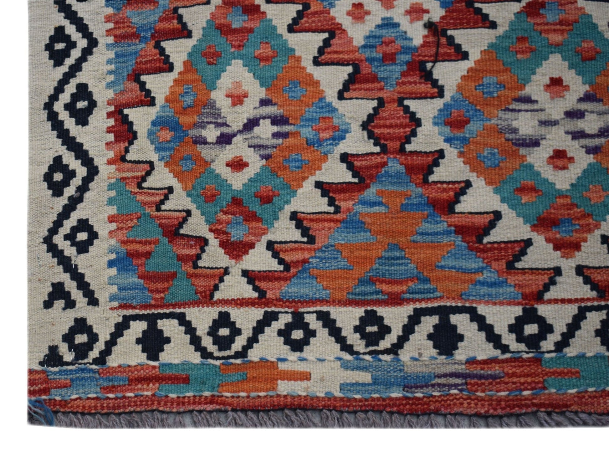 Handwoven Afghan Maimana wool runner featuring a geometric diamond pattern in vibrant colors.