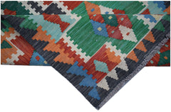 A handmade Afghan Maimana kilim runner featuring a vibrant geometric pattern in wool.
