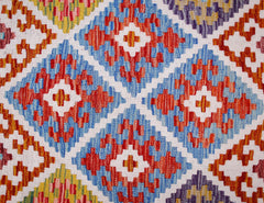 Handwoven Afghan Maimana kilim runner featuring a geometric diamond pattern in vibrant colors.