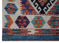Handwoven Afghan Maimana kilim runner featuring geometric patterns in vibrant wool colors.