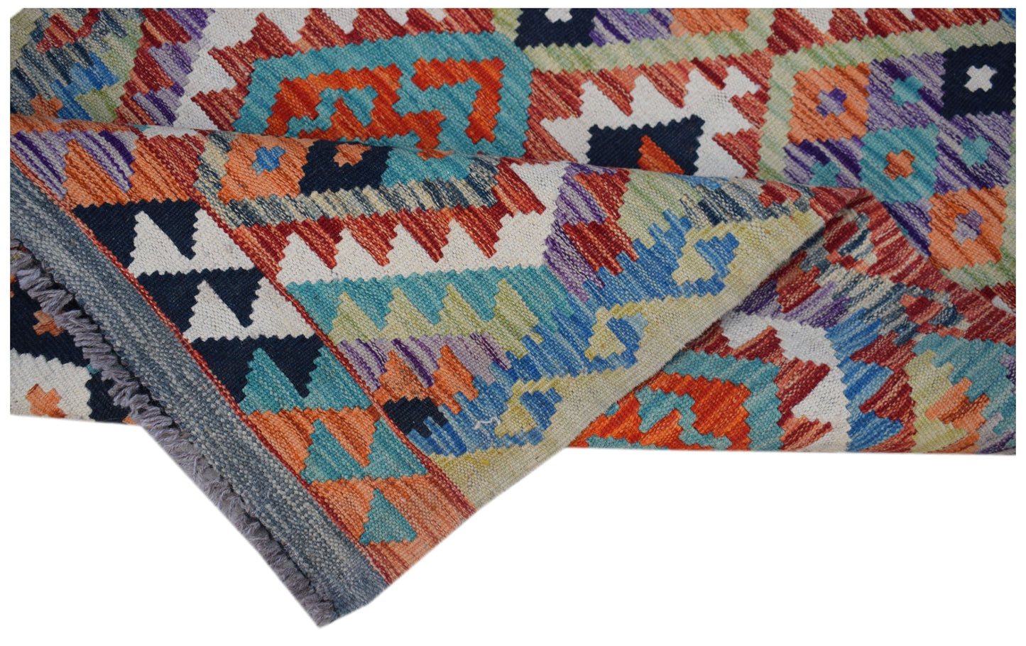 A handwoven Afghan Maimana wool runner featuring a vibrant geometric pattern in a flatweave style.