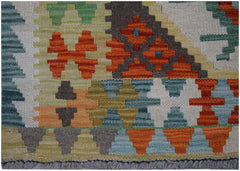 Handwoven Afghan Maimana kilim runner featuring a colorful geometric pattern in wool.