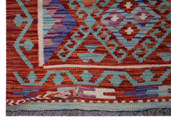 A close-up of an Afghan Maimana Kilim runner featuring geometric patterns in red, blue, and purple.