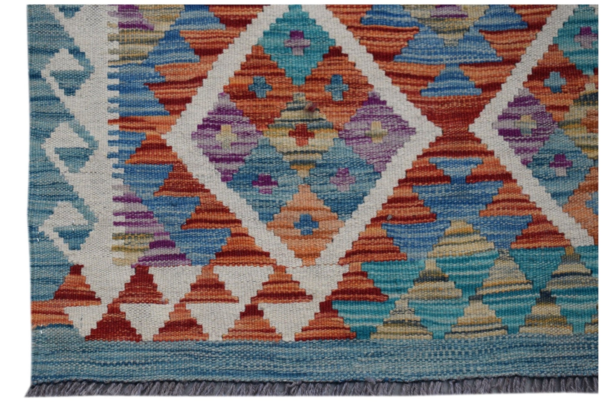 Handwoven Afghan Maimana wool kilim runner featuring a colorful geometric diamond pattern.