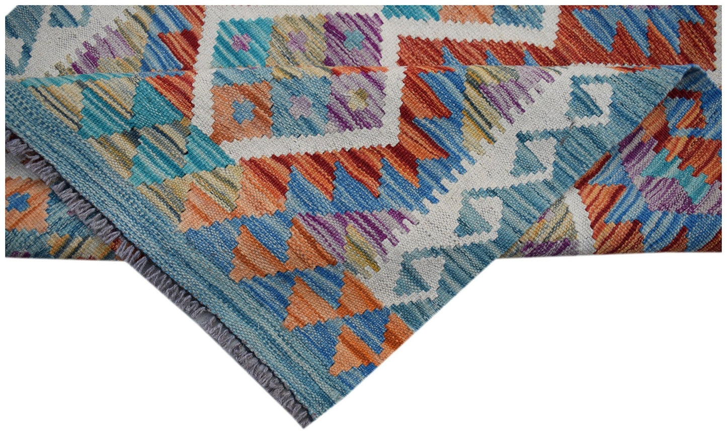 A handmade Afghan Maimana kilim runner featuring a vibrant geometric pattern in wool.
