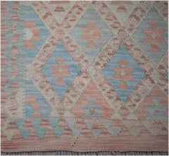 Handmade Afghan Maimana kilim runner featuring a geometric diamond pattern in soft blue and pink.