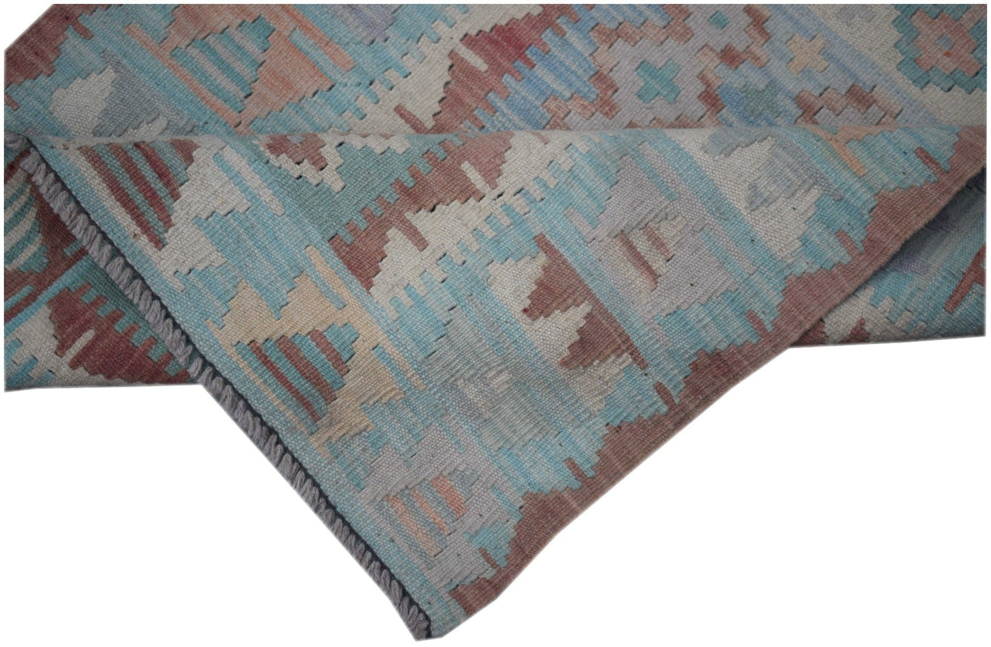 A handmade Afghan Maimana Kilim runner featuring a geometric pattern in blue, red, and beige.
