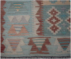 Handmade Afghan Maimana kilim runner featuring geometric patterns in blue, red, and cream wool.