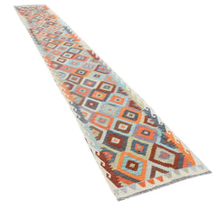 A handmade Afghan Maimana kilim runner featuring a colorful geometric diamond pattern.