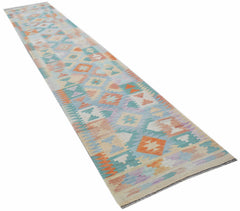A handmade Afghan Maimana Kilim runner featuring a geometric pattern in soft pastel colors.
