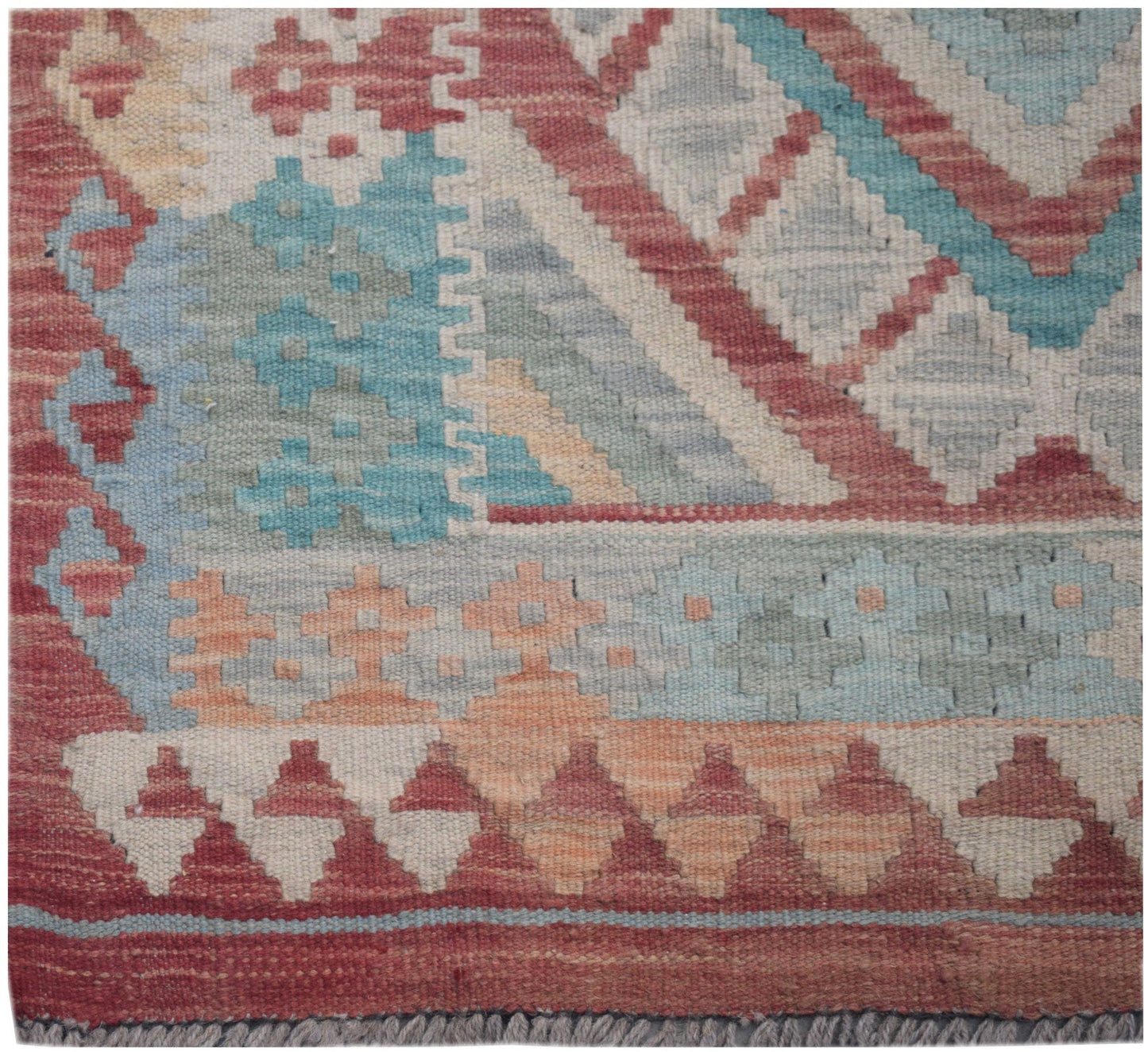 Handmade Afghan Maimana kilim runner featuring geometric patterns in red, blue, and cream wool.