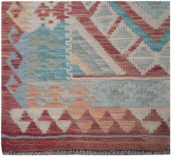 Handmade Afghan Maimana kilim runner featuring geometric patterns in red, blue, and cream wool.