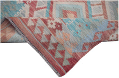 A handmade Afghan Maimana kilim runner featuring geometric patterns in red, blue, and cream wool.