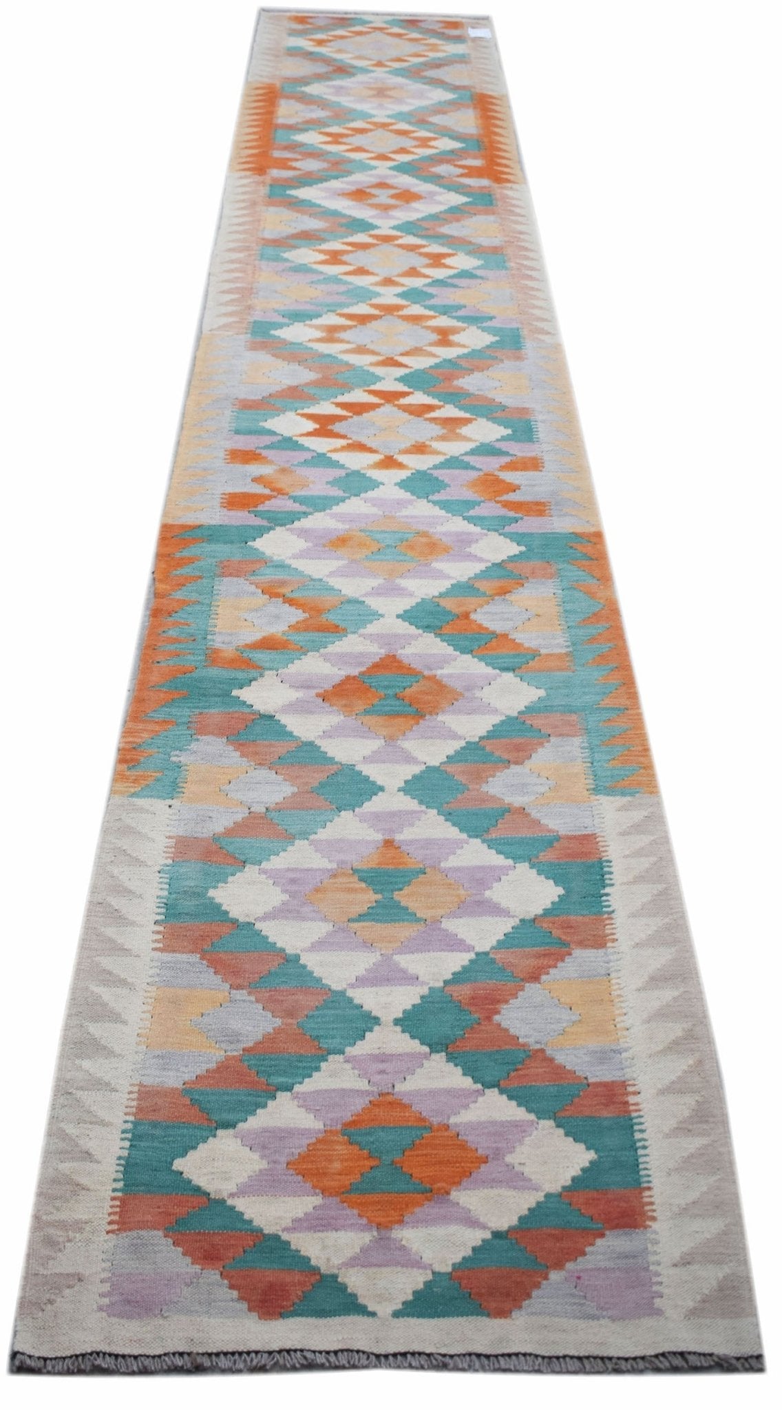 Handwoven Afghan Maimana wool runner rug featuring a colorful geometric diamond pattern.