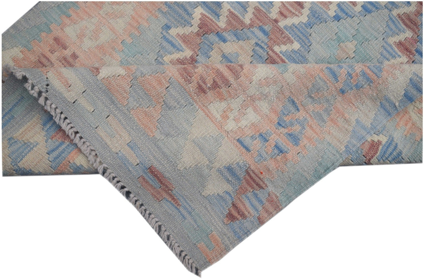 A handmade Afghan Maimana kilim runner featuring geometric patterns in soft blue and peach tones.