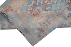 A handmade Afghan Maimana kilim runner featuring geometric patterns in soft blue and peach tones.